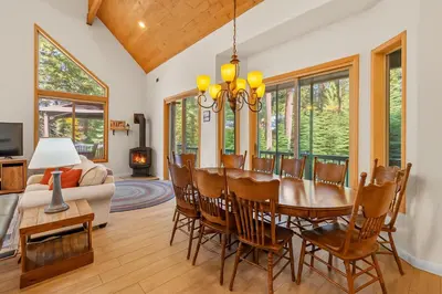 a living room with a dining room table and chairs at Leisure Landing Unwind in the Pines in Shaver Lake