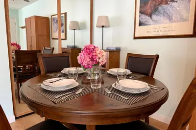 a dining room table with plates and flowers on it at Renovated Mountain Getaway, AC, Spa, Pool, Full Kitchen in Mammoth Lakes