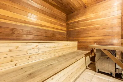 a sauna with wooden walls and a wooden bench at Renovated Mountain Getaway, AC, Spa, Pool, Full Kitchen in Mammoth Lakes