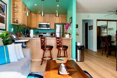 a living room with a couch and a kitchen at Renovated Mountain Getaway, AC, Spa, Pool, Full Kitchen in Mammoth Lakes