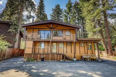 a large house with a balcony on top of it at Retreat with Private Hot Tub steps North Lake Tahoe in Carnelian Bay