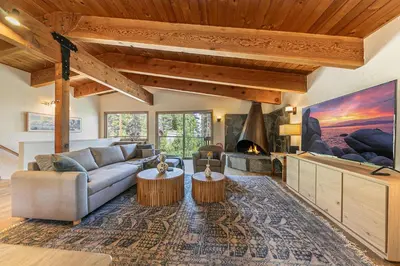 a living room with a couch and a fireplace at Retreat with Private Hot Tub steps North Lake Tahoe in Carnelian Bay