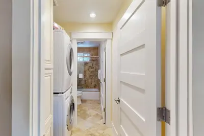 a bathroom with a washer and dryer next to a door at Brown Bear's Hideaway in Incline Village