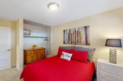 a bedroom with a red bed with a red blanket at Brown Bear's Hideaway in Incline Village