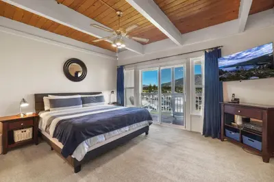 a bedroom with a bed and a ceiling fan at Tahoe Keys Townhouse with Boat Dock in South Lake Tahoe