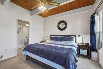 a bedroom with a bed and a ceiling fan at Tahoe Keys Townhouse with Boat Dock in South Lake Tahoe