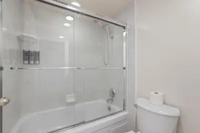 a bathroom with a shower and a toilet with a glass door at Tahoe Keys Townhouse with Boat Dock in South Lake Tahoe