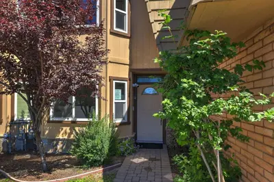 a front door of a house with a tree at Tahoe Keys Townhouse with Boat Dock in South Lake Tahoe
