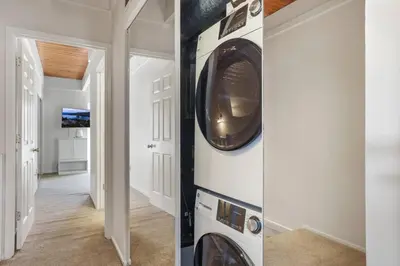 a hallway with a washer and dryer in a house at Tahoe Keys Townhouse with Boat Dock in South Lake Tahoe