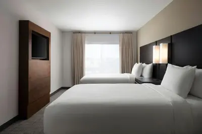 a hotel room with two beds and a television at Residence Inn by Marriott Reno South in Reno