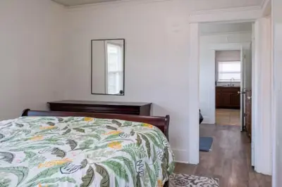a bedroom with a bed and a mirror on the wall at 2BR Family Getaway with Yard Kitchen and Parking in Lodi