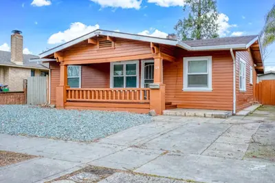 a wooden house with a driveway in front of it at 2BR Family Getaway with Yard Kitchen and Parking in Lodi