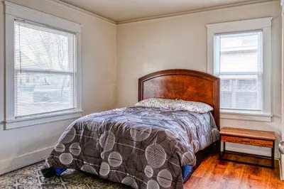 a bedroom with a bed and two windows at 2BR Family Getaway with Yard Kitchen and Parking in Lodi