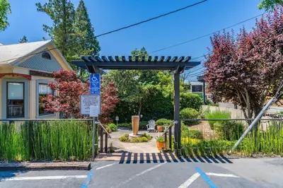 a gate to a parking lot in front of a house at Hanford House in Sutter Creek