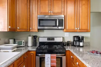 a kitchen with a stove and a microwave at Cozy Home 7 minutes Walk to UC Davis Sacramento in Sacramento
