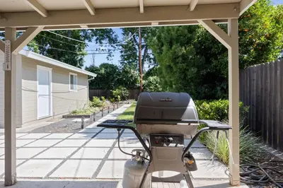 a bbq grill sitting under a pergola at Cozy Home 7 minutes Walk to UC Davis Sacramento in Sacramento
