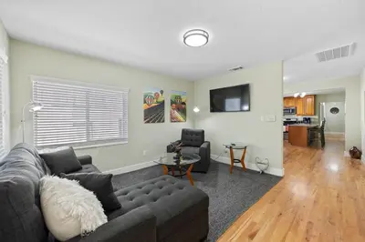 a living room with a couch and a table at Cozy Home 7 minutes Walk to UC Davis Sacramento in Sacramento