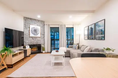 a living room with a couch and a fireplace at Lux Retreat, Covered Parking, Walk to Golf in Mammoth Lakes