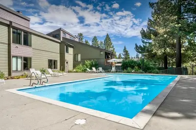 a swimming pool in front of a house at Lux Retreat, Covered Parking, Walk to Golf in Mammoth Lakes