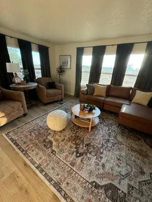 a living room with a couch and a table at Scenic Ranch Retreat Near Fresno in Fresno