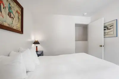 a white bedroom with a white bed with white pillows at 3 Bedroom Kirkwood Condo – Base Camp condo in Kirkwood