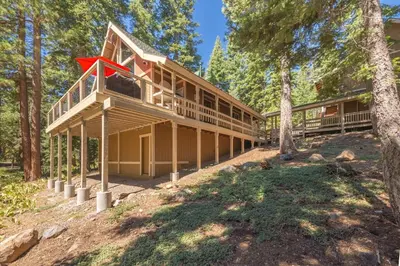 a house in the woods with a red roof at Jester Court home in Tahoe Vista