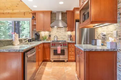 a kitchen with wooden cabinets and stainless steel appliances at Jester Court home in Tahoe Vista