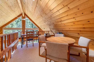 a room with a wooden ceiling with a table and chairs at Jester Court home in Tahoe Vista