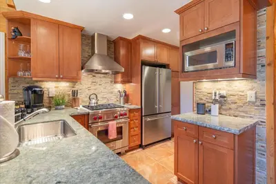 a kitchen with wooden cabinets and stainless steel appliances at Jester Court home in Tahoe Vista