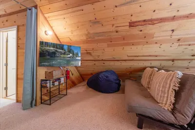 a living room with a couch in a wooden wall at Jester Court home in Tahoe Vista