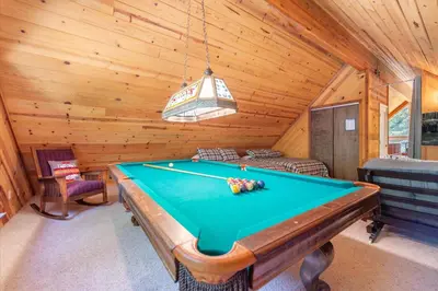 a room with a pool table in a cabin at Jester Court home in Tahoe Vista