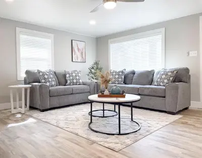 a living room with a couch and a table at Country Living 3BR with fenced yard on Mooney in Visalia