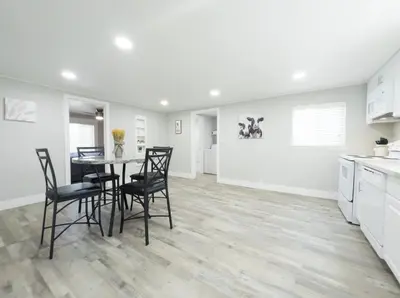 a kitchen and dining room with a table and chairs at Country Living 3BR with fenced yard on Mooney in Visalia