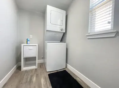 a small kitchen with a white refrigerator and a microwave at Cozy Entire Home Gateway to Sequoia Pet Friendly in Visalia