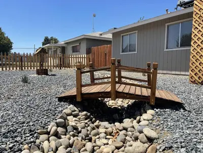 a wooden bench sitting on top of a pile of rocks at Lovely home central Coalinga-2BR Stopover near I-5 in Coalinga