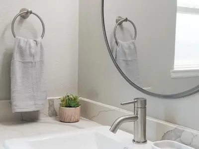 a bathroom with a sink and a mirror at Ocean Breeze 2 bedroom w fenced yard on Mooney in Visalia