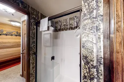 a glass door in a room with a wall at Sierra Megeve 6 in Mammoth Lakes