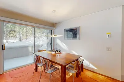 a dining room with a wooden table and chairs at Sierra Megeve 11 in Mammoth Lakes