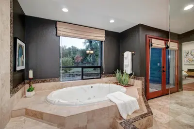 a large bathroom with a tub and a window at Elegant Granite Bay Getaway Tall Pine Home in Granite Bay