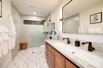 a bathroom with a sink and a toilet and a mirror at Elegant Granite Bay Getaway Tall Pine Home in Granite Bay
