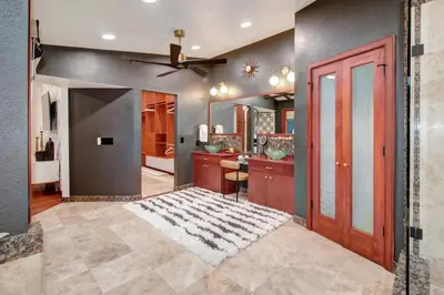 a living room with a ceiling fan and a door at Elegant Granite Bay Getaway Tall Pine Home in Granite Bay