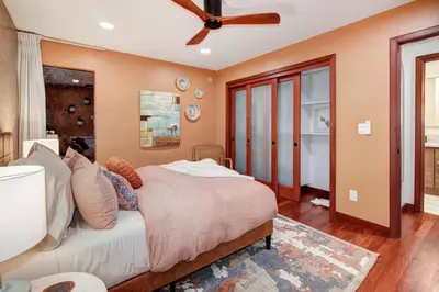a bedroom with a bed and a ceiling fan at Elegant Granite Bay Getaway Tall Pine Home in Granite Bay
