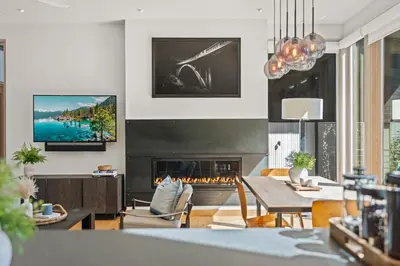 a living room with a table and a fireplace at Northstar Ski-In Ski-Out Luxury Townhome with Hot Tub in Truckee