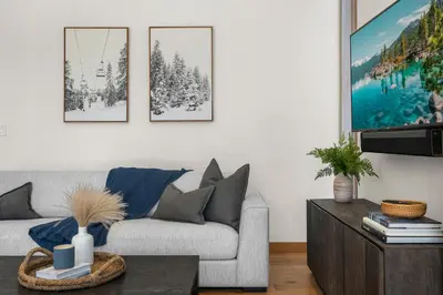 a living room with a couch and a table at Northstar Ski-In Ski-Out Luxury Townhome with Hot Tub in Truckee