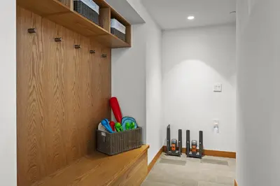 a room with a wooden door with a basket of pens at Northstar Ski-In Ski-Out Luxury Townhome with Hot Tub in Truckee