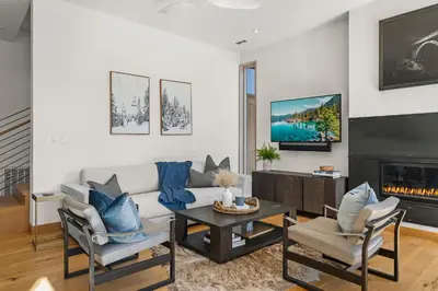 a living room with a couch and a fireplace at Northstar Ski-In Ski-Out Luxury Townhome with Hot Tub in Truckee