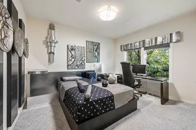 a bedroom with a bed and a desk in it at Vista De Lago Retreat Luxury Mansion with Pool and Theater in Granite Bay