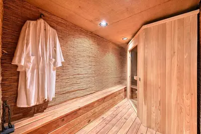 an empty sauna with an umbrella on a wooden wall at Vista De Lago Retreat Luxury Mansion with Pool and Theater in Granite Bay