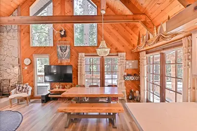 a living room with a table and a tv at Cozy Chic Chalet - Enchanting & Fun Family Retreat - Hot Tub & Fire Pit - Dog Friendly in Dorrington