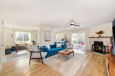 a living room with a blue couch and a fireplace at Gorgeous 4BR Home Massive Modern Home in Cameron Park